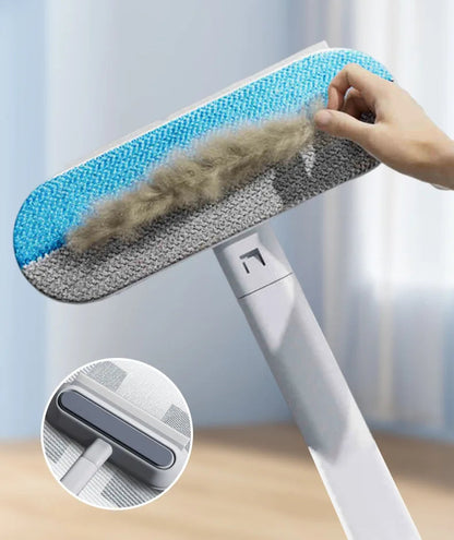 Cleaning tool with a brush head being used to remove hair, against a light blue background.